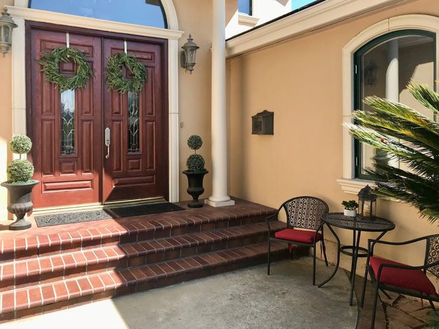 a front view of a house with outdoor seating