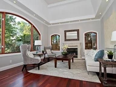 a living room with fireplace furniture and a large window