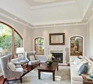 a living room with furniture a fireplace and a large window