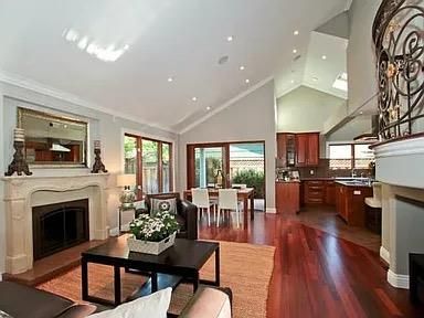 a living room with furniture a fireplace and a kitchen view