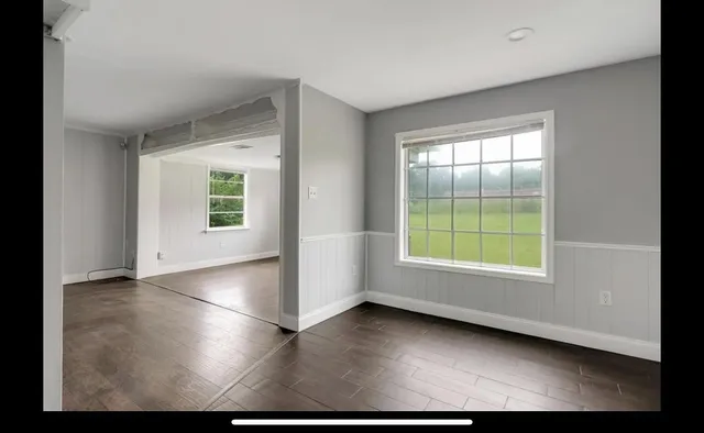 a view of a livingroom with an empty space and a window