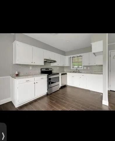 a kitchen with stainless steel appliances a sink and cabinets