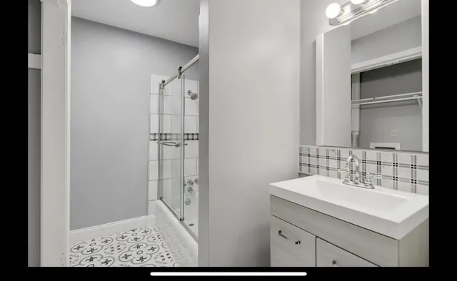 a bathroom with a sink and a mirror