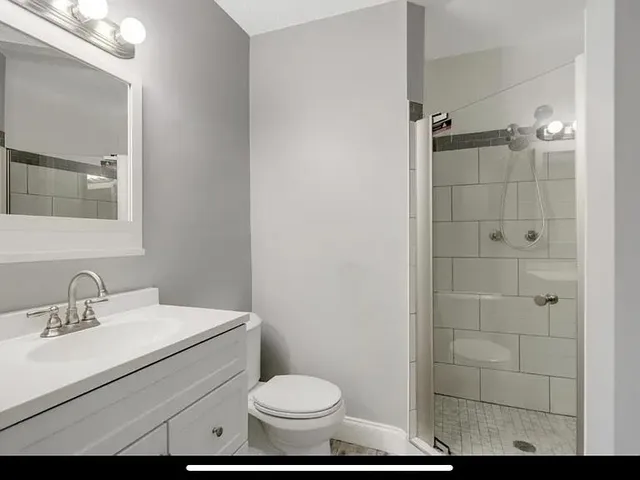 a bathroom with a sink toilet and shower