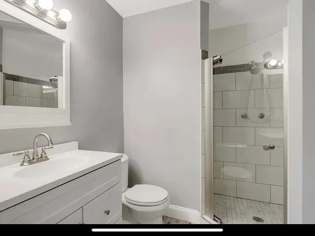 a bathroom with a sink toilet and shower
