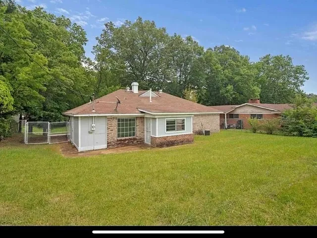 a front view of a house with yard and green space