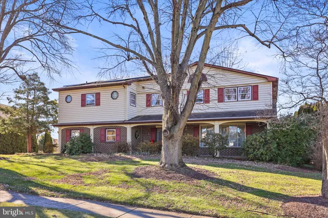 a view of a house with a yard and tree s