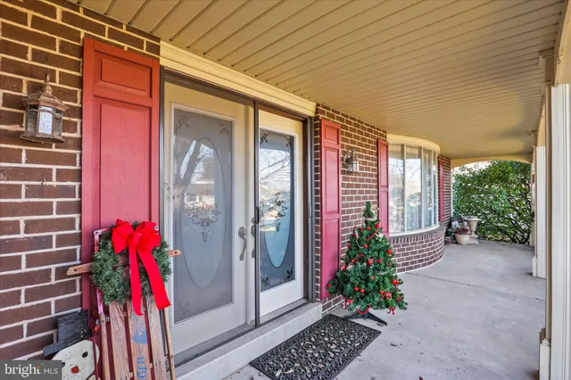a front view of a building with trees