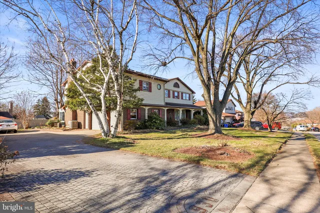 a view of a house with a yard covered in snow