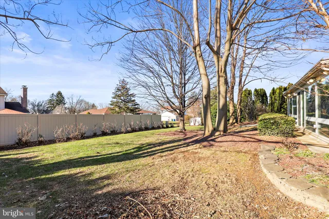 a view of a brick house with large windows and a tree