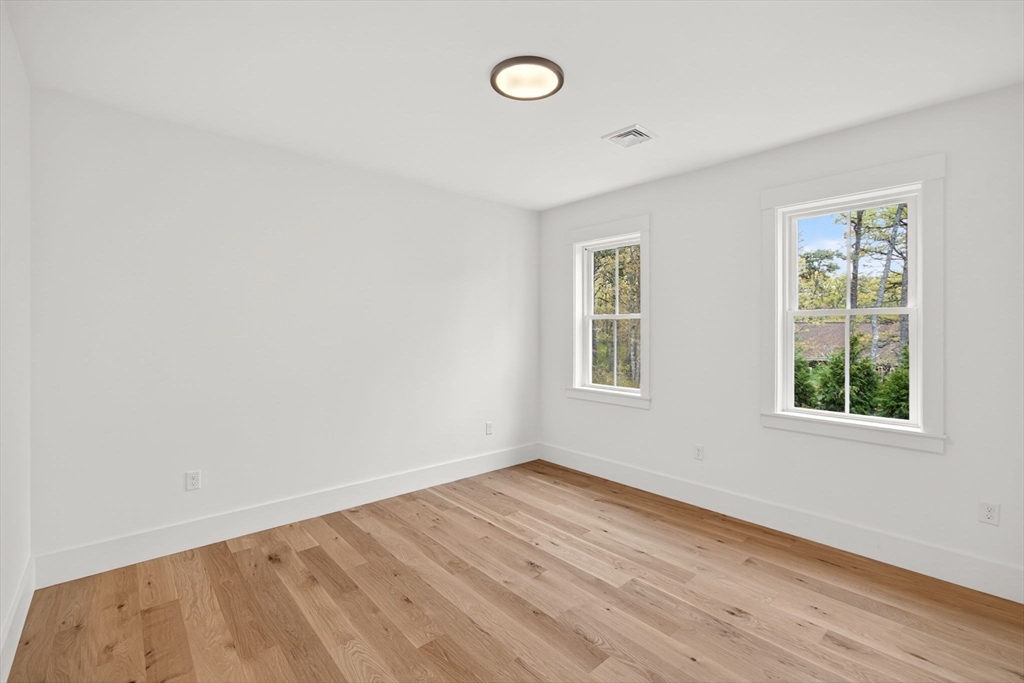 132 Great Western Road Harwich, MA 02645 - Photo 33 of 42 an empty room with wooden floor and windows
