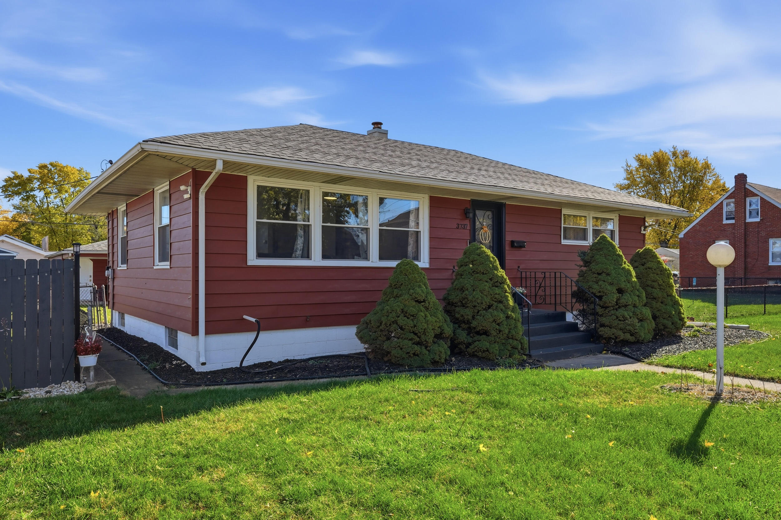 3737 Fillmore Street Gary, IN 46408 - Photo 4 of 19 a view of a house with a yard and plants