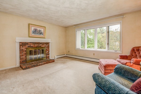 24 Fredrickson Road Billerica, MA 01821 - Photo 4 of 20 a living room with furniture a window and a fireplace