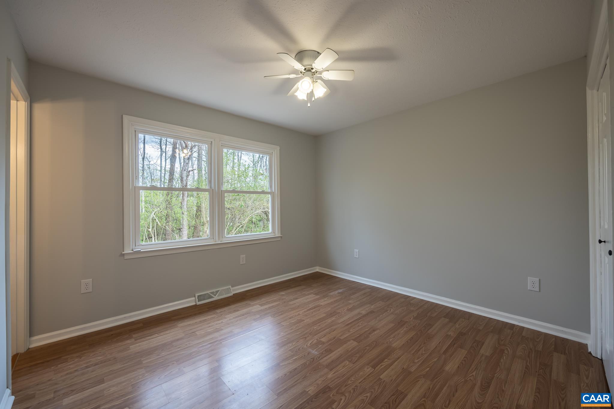 7971 Irish Road Faber, VA 22938 - Photo 11 of 23 an empty room with wooden floor and windows