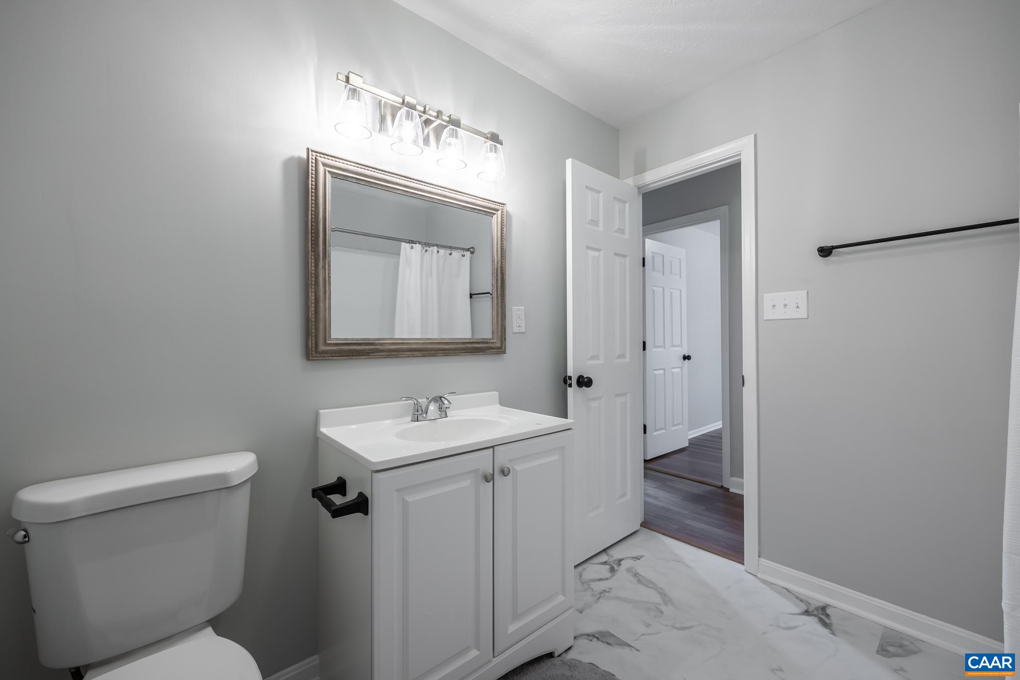 7971 Irish Road Faber, VA 22938 - Photo 17 of 23 a bathroom with a toilet sink and mirror
