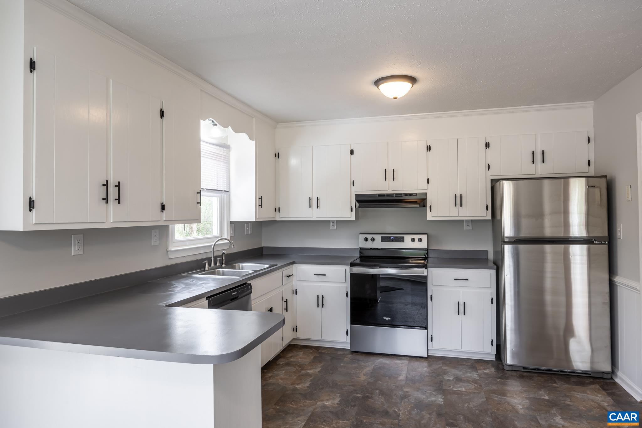 7971 Irish Road Faber, VA 22938 - Photo 5 of 23 a kitchen with stainless steel appliances granite countertop a sink a stove a refrigerator and white cabinets