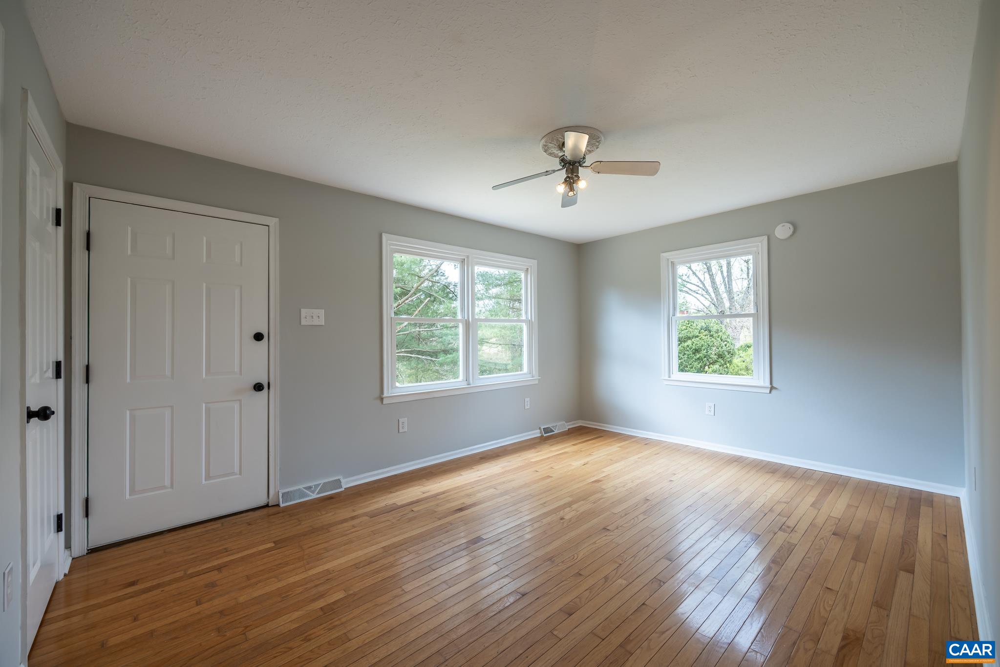 7971 Irish Road Faber, VA 22938 - Photo 7 of 23 a view of an empty room with a window and wooden floor