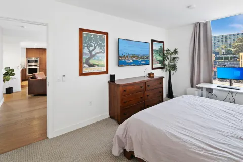 a bedroom with a bed and a flat screen television