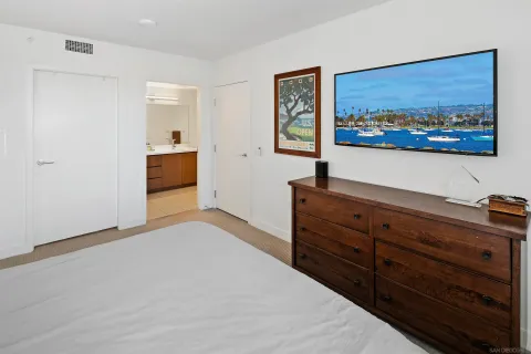 a bedroom with a bed and a cabinet
