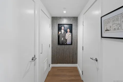 a view of a hallway with wooden floor