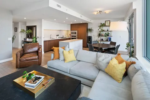 a living room with furniture and kitchen view