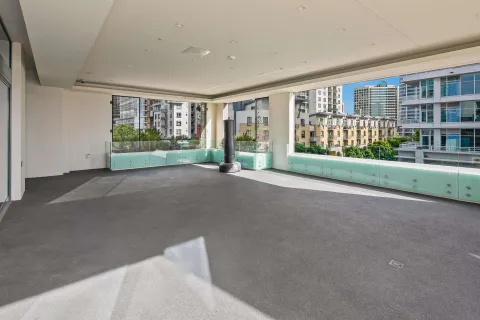 a room with lots of tables a large window and chairs