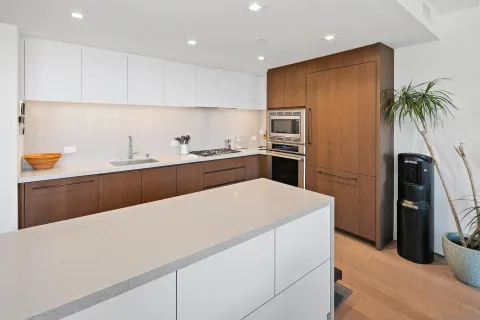 a kitchen with stainless steel appliances a sink stove and refrigerator