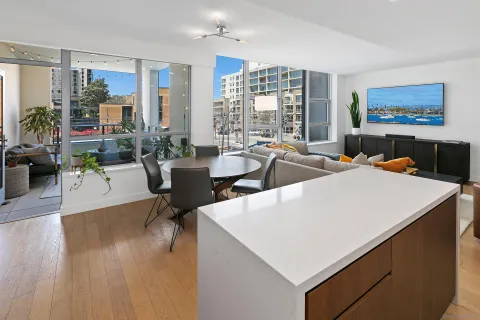 a living room with fireplace furniture and a large window