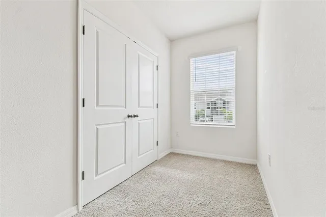 a view of an empty room and a window