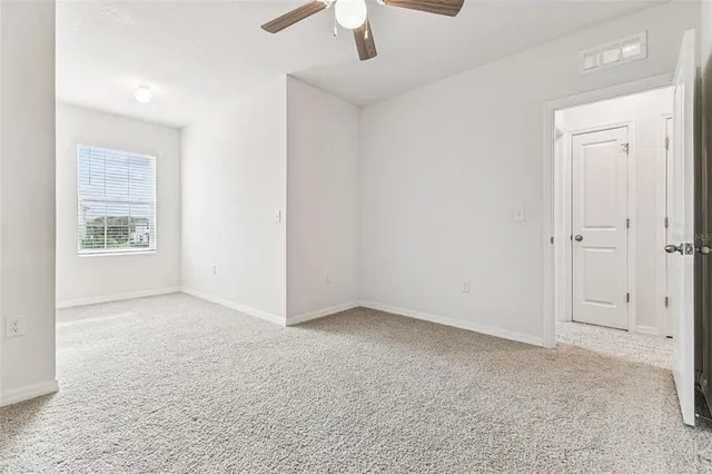 a bathroom with a granite countertop sink and a toilet