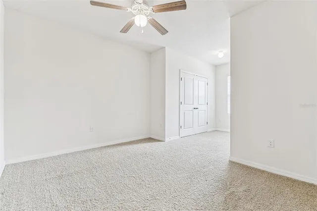 a white bath tub sitting next to a white toilet and a shower