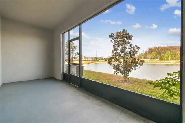 a view of a lake with a big yard and large trees