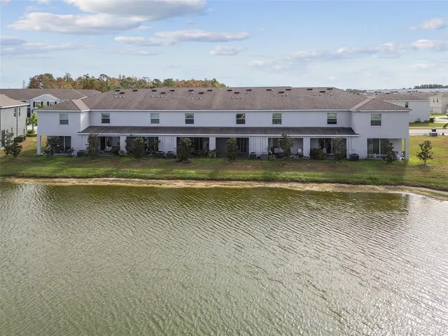 an aerial view of residential houses with outdoor space and swimming pool