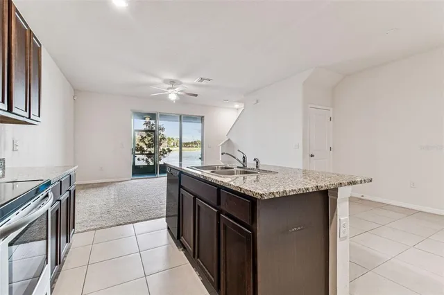 a view of a livingroom with a furniture ceiling fan and window
