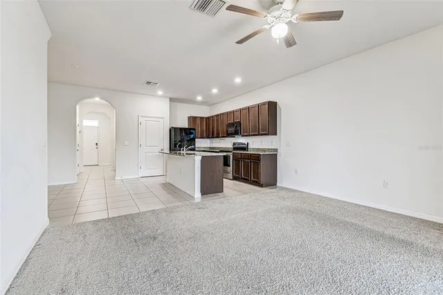 an empty room with fan and a ceiling fan