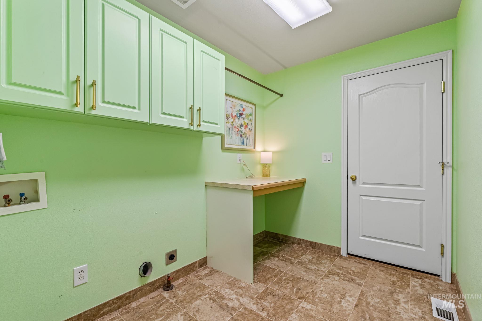 6099 North Heathrow Way Boise, ID 83713 - Photo 20 of 39 Laundry room featuring hookup for a washing machine, electric dryer hookup, and cabinet space