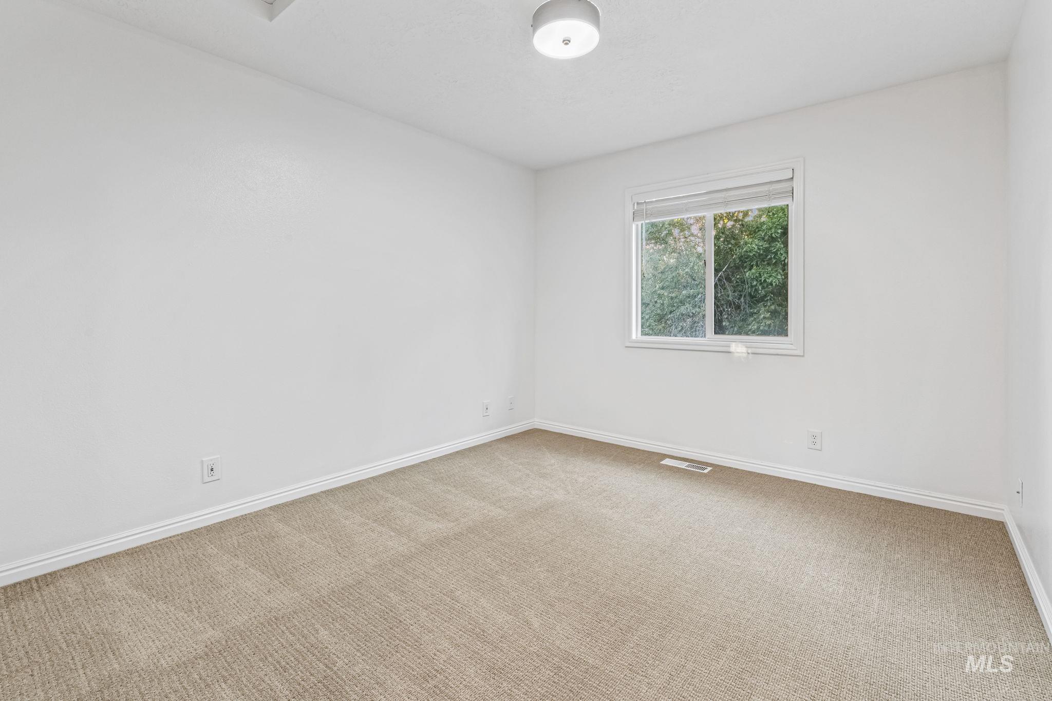6099 North Heathrow Way Boise, ID 83713 - Photo 22 of 39 Empty room featuring carpet and baseboards