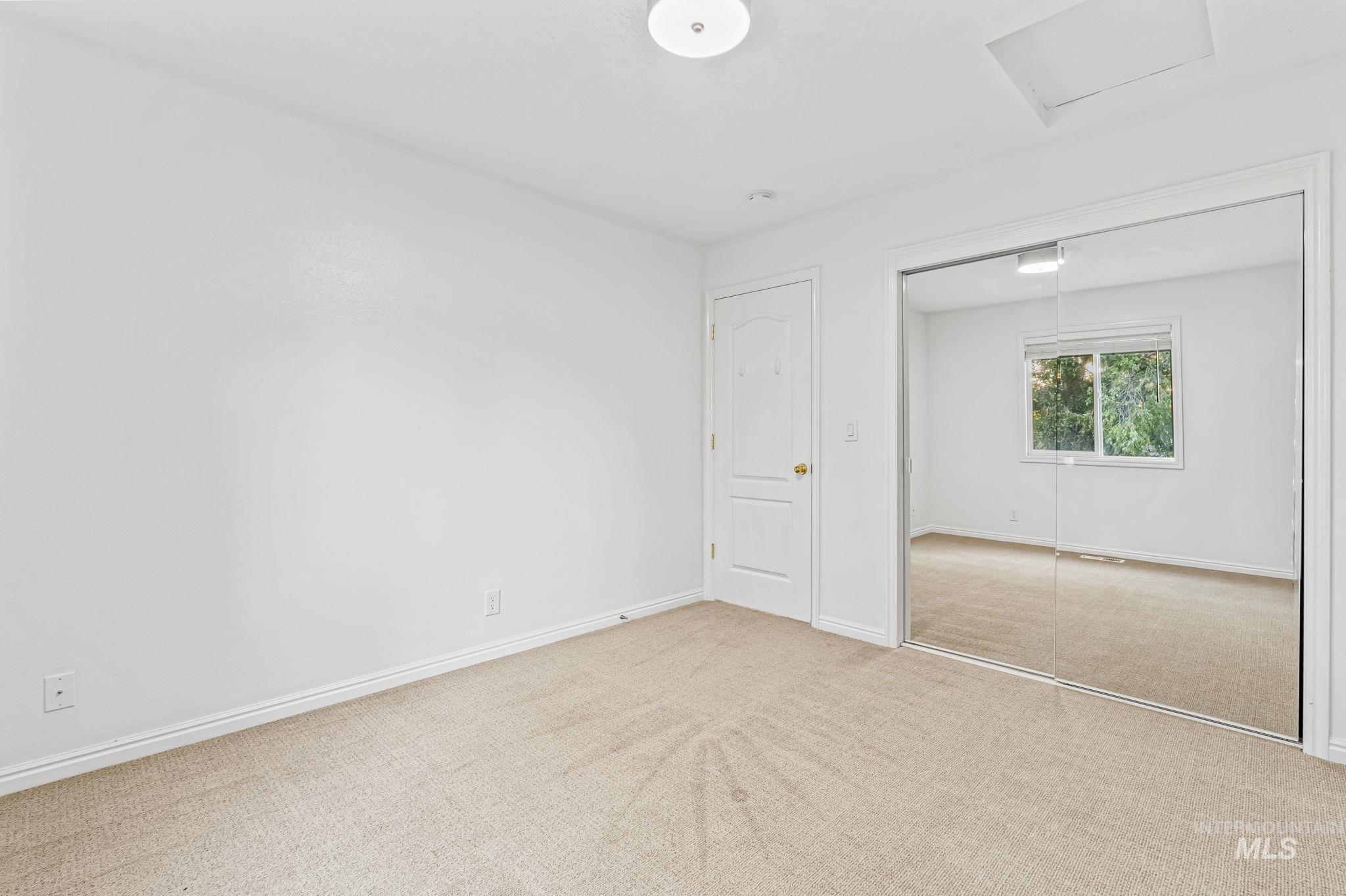 6099 North Heathrow Way Boise, ID 83713 - Photo 23 of 39 Unfurnished bedroom with carpet flooring, attic access, and a closet