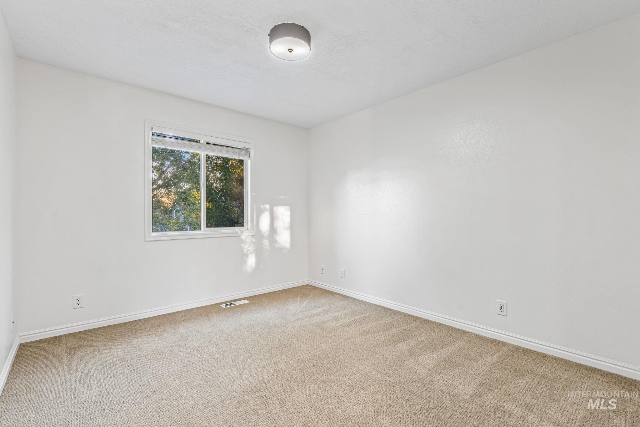 6099 North Heathrow Way Boise, ID 83713 - Photo 24 of 39 Empty room with carpet flooring and baseboards