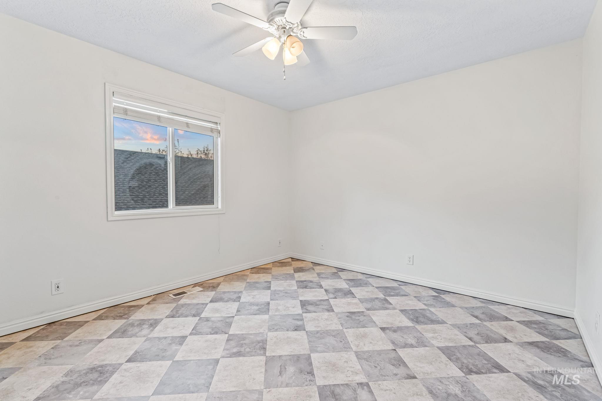 6099 North Heathrow Way Boise, ID 83713 - Photo 27 of 39 Bedroom with baseboards and ceiling fan
