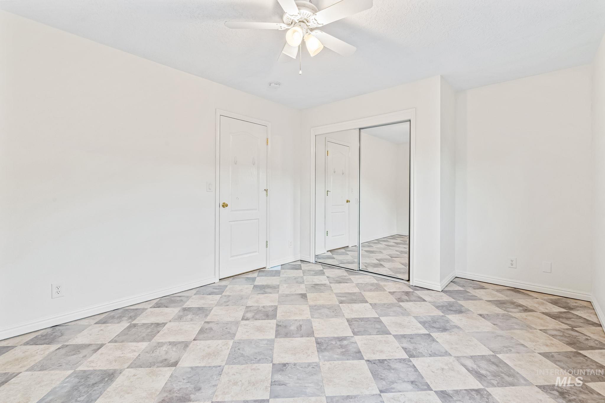 6099 North Heathrow Way Boise, ID 83713 - Photo 28 of 39 Unfurnished bedroom featuring ceiling fan and a closet