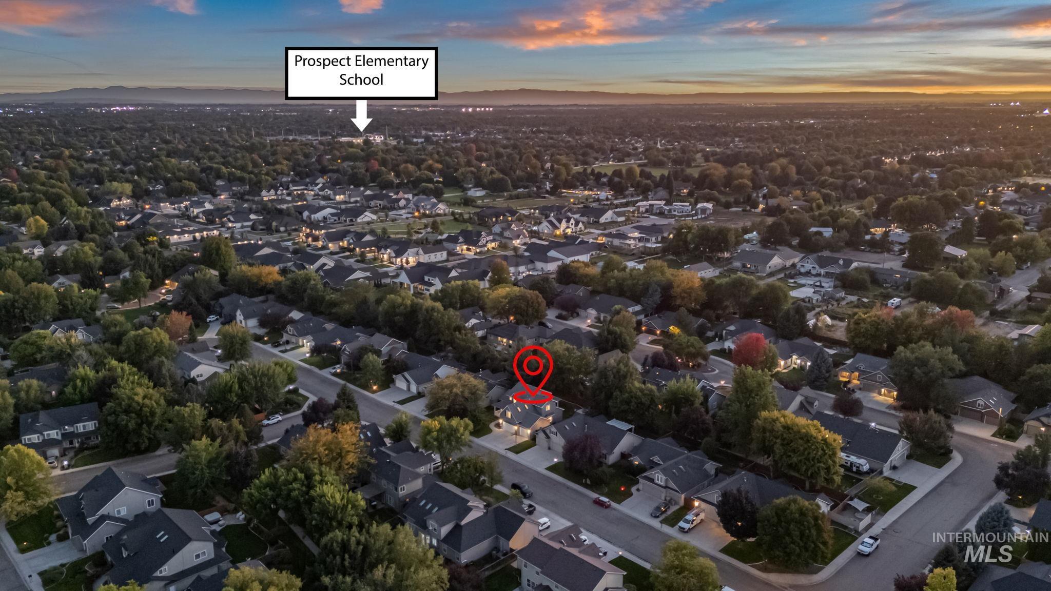 6099 North Heathrow Way Boise, ID 83713 - Photo 35 of 39 Aerial view of property and surrounding area featuring nearby suburban area and a mountainous background