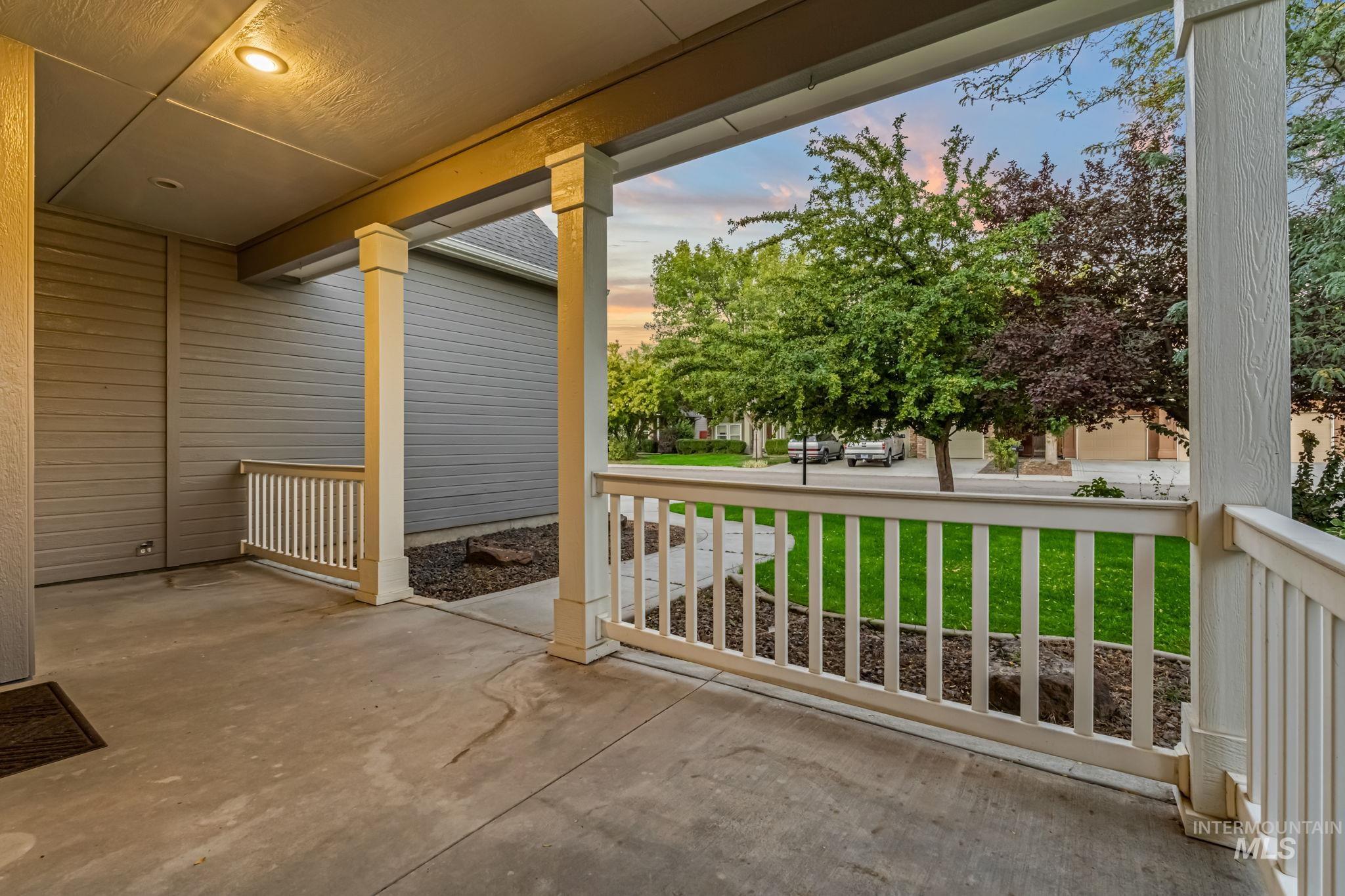 6099 North Heathrow Way Boise, ID 83713 - Photo 4 of 39 Patio terrace at dusk with covered porch and a lawn