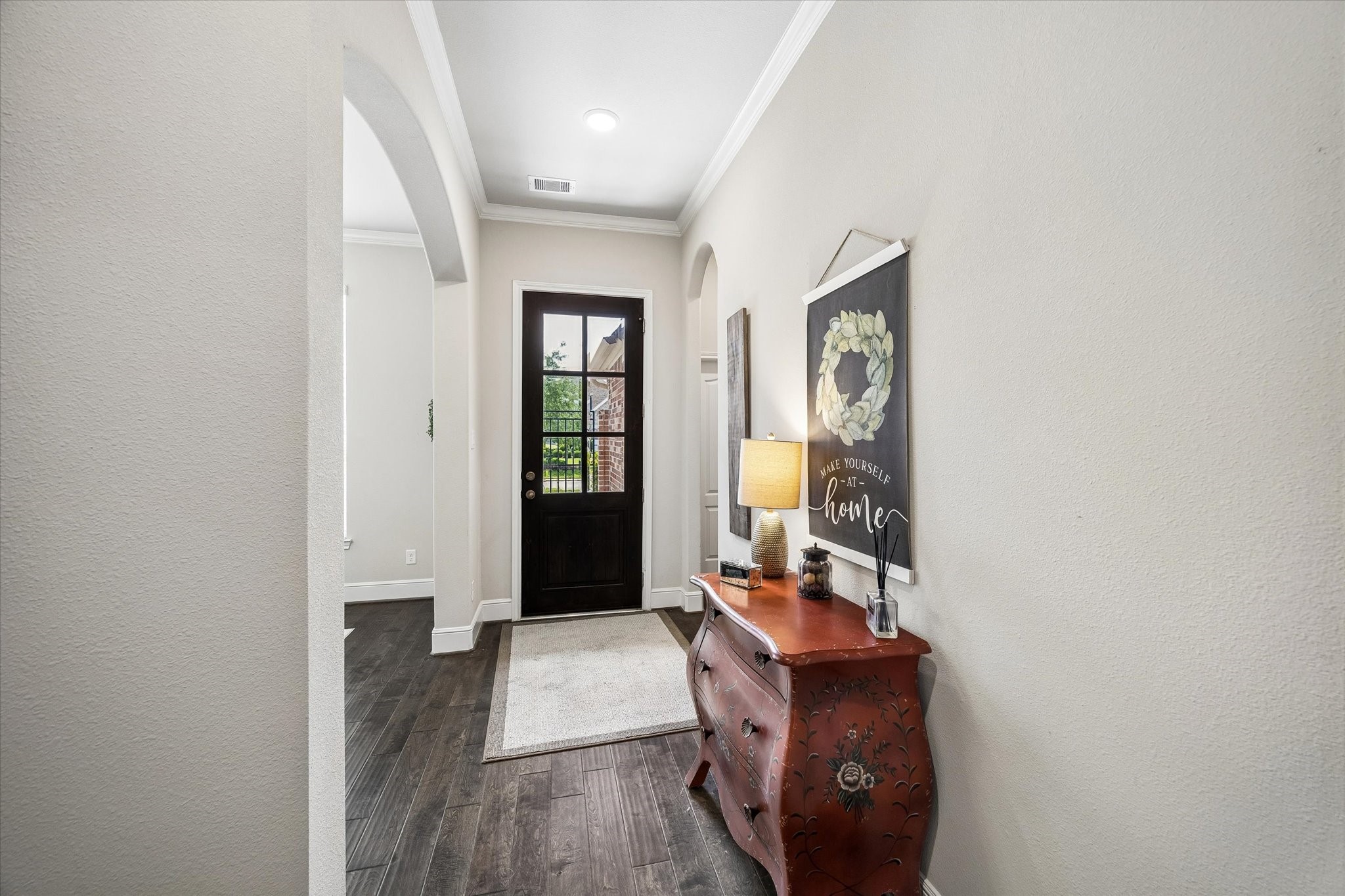 19 Peace Tree Way Tomball, TX 77375 - Photo 5 of 36 Stunning front entryway featuring soaring ceilings and elegant crown molding with lovely wood floors.