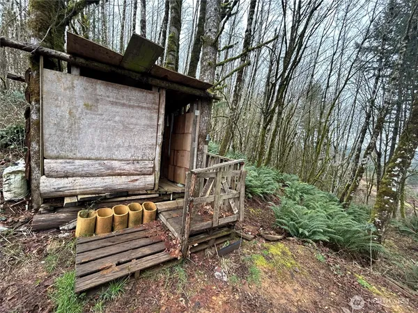 a view of a wooden bench sitting in middle of a yard