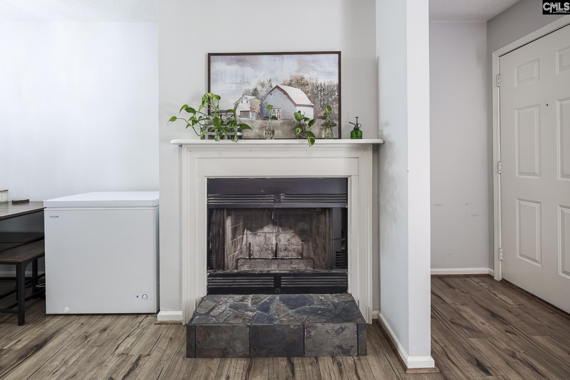 152 Thames Valley Court Irmo, SC 29063 - Photo 10 of 32 a view of an empty room with wooden floor a fireplace and a window