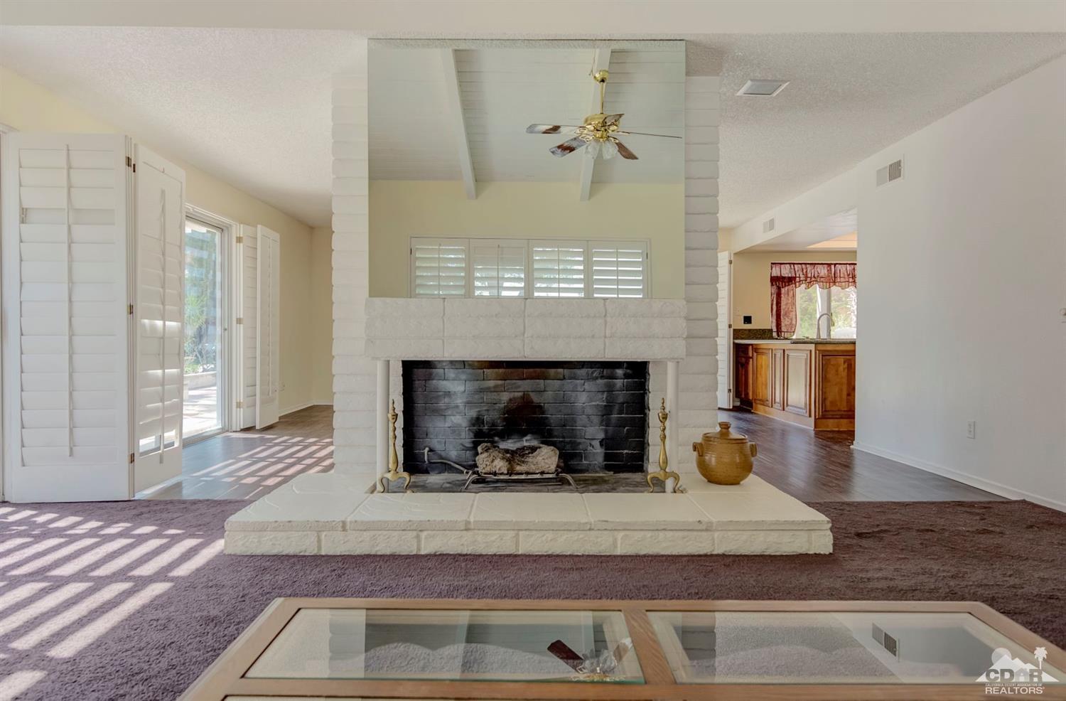 73769 Haystack Road Palm Desert, CA 92260 - Photo 1 of 34 a living room with furniture and a fireplace