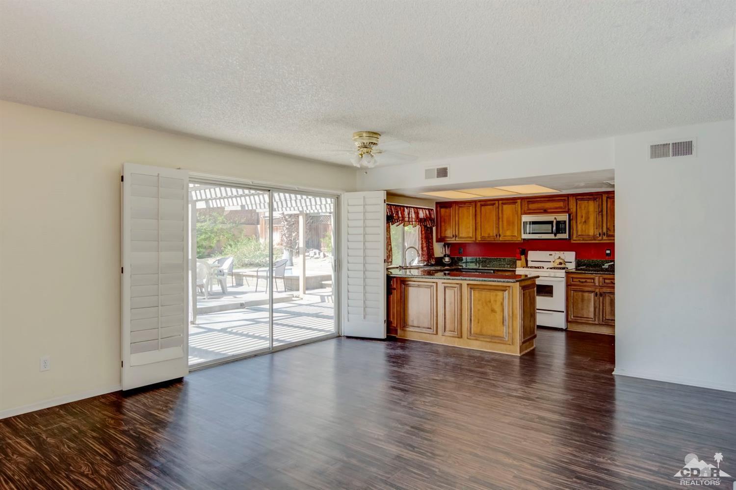 73769 Haystack Road Palm Desert, CA 92260 - Photo 2 of 34 a kitchen with stainless steel appliances granite countertop a stove and a refrigerator