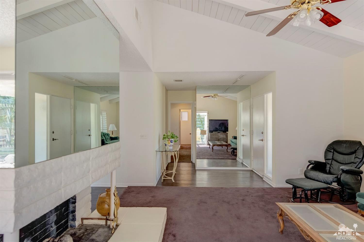73769 Haystack Road Palm Desert, CA 92260 - Photo 11 of 34 a living room with furniture and a flat screen tv