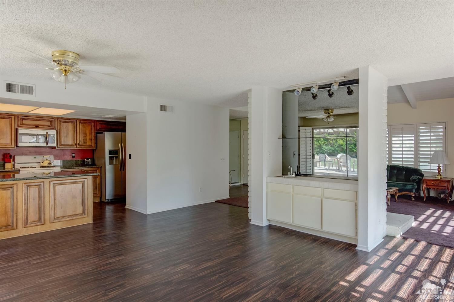 73769 Haystack Road Palm Desert, CA 92260 - Photo 12 of 34 a view of a kitchen with dishwasher and wooden floor